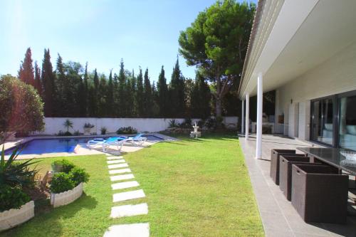 a backyard of a house with a swimming pool at ARENDA Villa Perla in Hospitalet de l'Infant