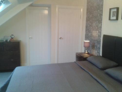 a bedroom with a bed and a lamp on a table at Avenue Road in Gateshead