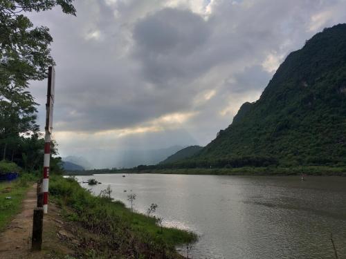 a view of a river with mountains in the background at Charm's Homestay in Phong Nha