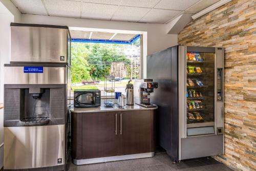a kitchen with a stove and a refrigerator at Motel 6-Elmsford, NY - White Plains in Elmsford