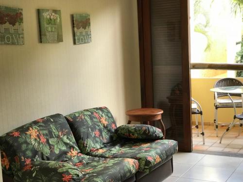 a couch sitting in a living room next to a table at Pipa Flat Solar in Pipa