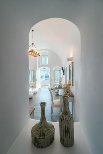 two vases sitting on a table in a living room at Angel Luxury Suites in Fira