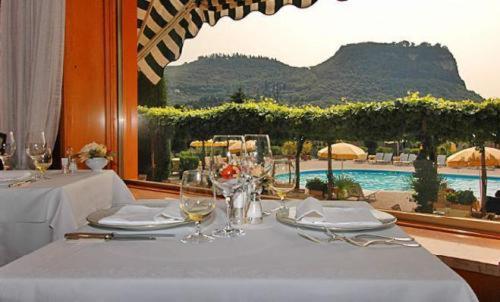 
a dining room table with a white tablecloth at Hotel Garden in Garda
