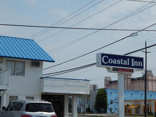 a sign for a coastal inn in front of a building at Coastal Inn - Ocean City in Ocean City