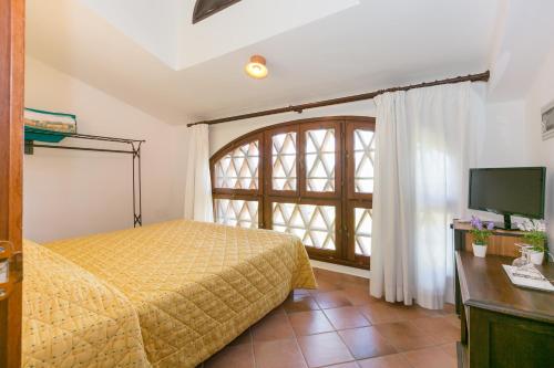 1 dormitorio con cama y ventana grande en Le Camere del Relais La Pieve Vecchia, en Riparbella