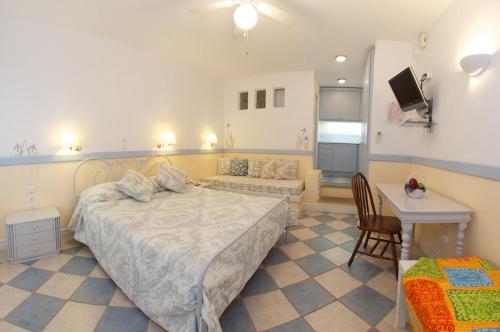 a bedroom with a bed and a couch and a table at Roi Boutique Suites in Asos