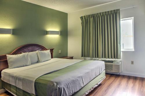 a bedroom with a large bed and a window at Motel 6-Dallas, TX - Northwest in Dallas