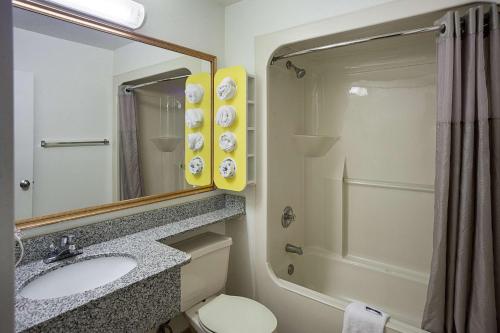 a bathroom with a sink and a toilet and a mirror at Motel 6-Binghamton, NY in Binghamton