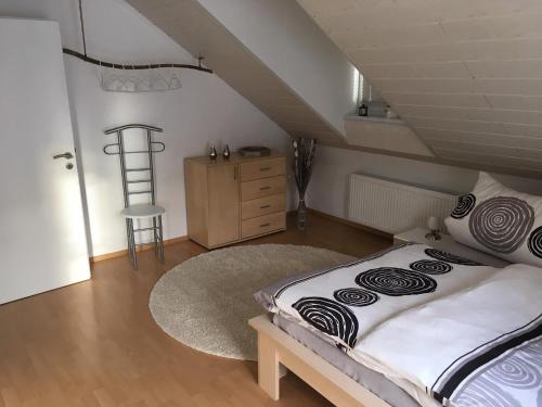 a bedroom with a bed and a dresser and a ladder at Zur Burgmauer in Welschbillig