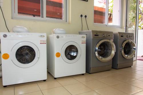 four washing machines and a washer and dryer in a room at Shaligram Hotel in Pātan
