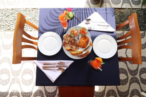 a blue table with a plate of food on it at Holland Lodge Paramaribo in Paramaribo