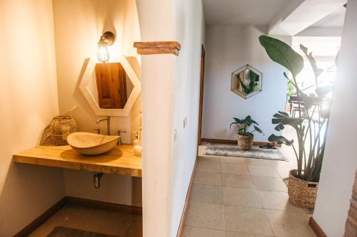 a bathroom with a wooden counter with a bowl on a table at Dreamsea Surf Guest House in Sintra