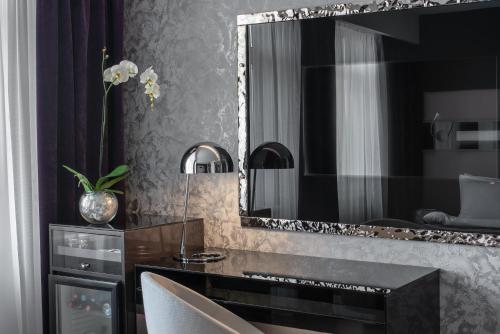 a bathroom with a large mirror and a desk at 11 Mirrors Design Hotel in Kyiv