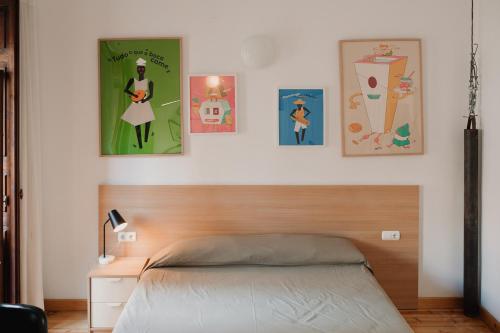 バレンシアにあるLa Casona Beach Houseのベッドルーム1室(ベッド1台付)が備わります。壁に4枚の写真が飾られています。