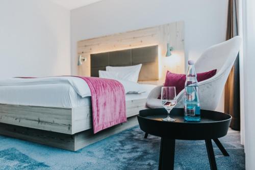 a bedroom with a bed and a table with wine glasses at FischerS in Kassel