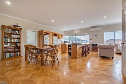 a kitchen and dining room with a table and chairs at Serpentine Rose in Albany