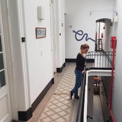 a woman standing on a machine in a room at IDEAL SOCIAL Hostel in Buenos Aires