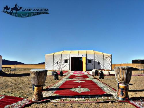 a tent with a red carpet in the desert at Sahara Luxury Camp in Zagora