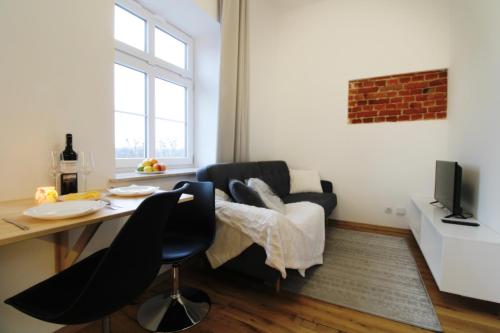 a living room with a couch and a table at Aparthotel Tectum TectumApartments in Wrocław