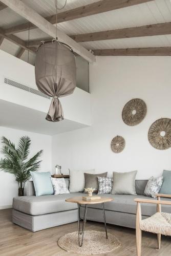 a living room with a couch and a table at Seaside A Lifestyle Resort - Adults Only in Agia Pelagia