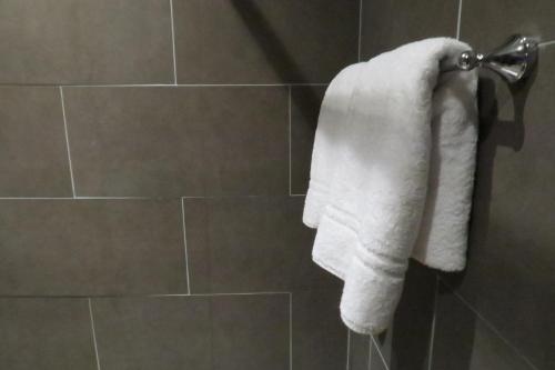 a towel hanging on a towel rack in a bathroom at Quay Apartments Clarence House in Newport