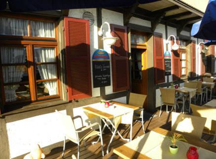 a patio of a restaurant with tables and chairs at Hotel Restaurant Adler Bühlertal in Bühlertal