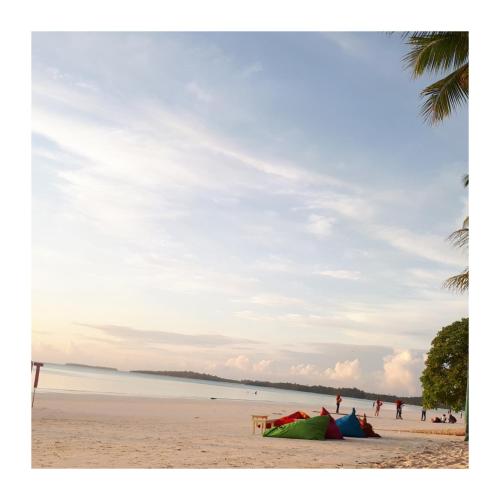 a beach with a group of tents on the sand at Mercy Cottage in Langgur