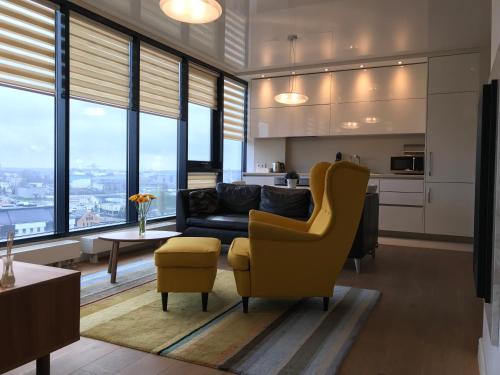 a living room with a couch and a chair at Old Town Panorama Apartments in Klaipėda
