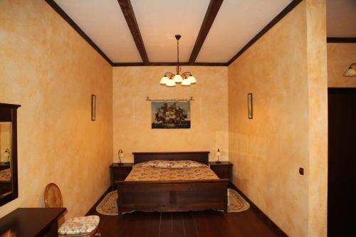 a bedroom with a bed in the corner of a room at Gnizdo Golubky in Shaian