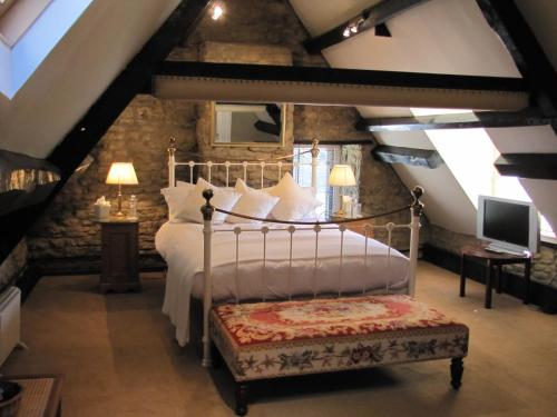 a bedroom with a bed in a attic at The Inn at Fossebridge in Chedworth