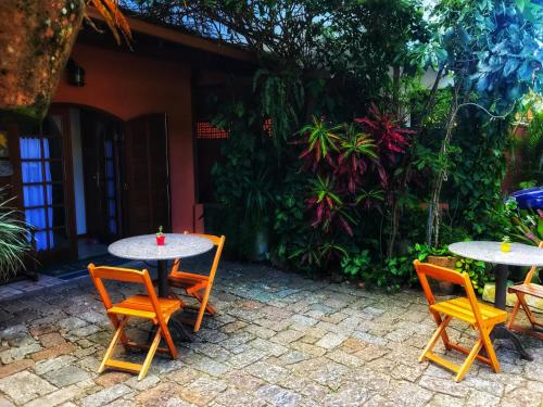 a couple of tables and chairs in a courtyard at GH Bizkaia in Florianópolis