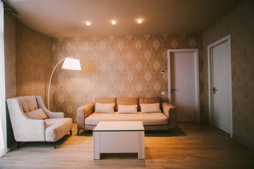 a living room with a couch and a table at Savaneti Eco Hotel in Tʼelavi