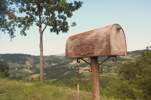 a rusted mailbox sitting on top of a hill at Il Casale-toscoemiliano in Camugnano