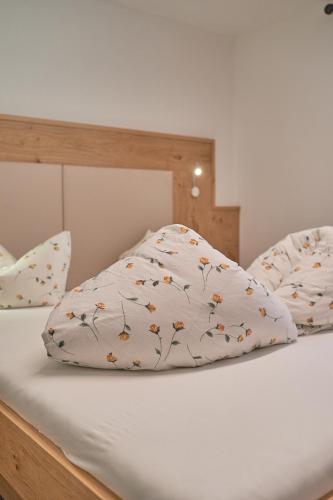 a bed with a pillow on top of it at Hotel Garni Schönblick in Sölden