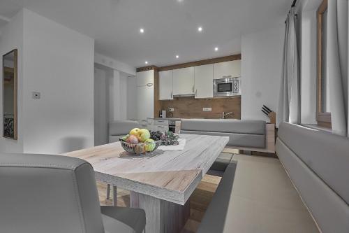 a kitchen with a table with a bowl of fruit on it at Hotel Garni Schönblick in Sölden