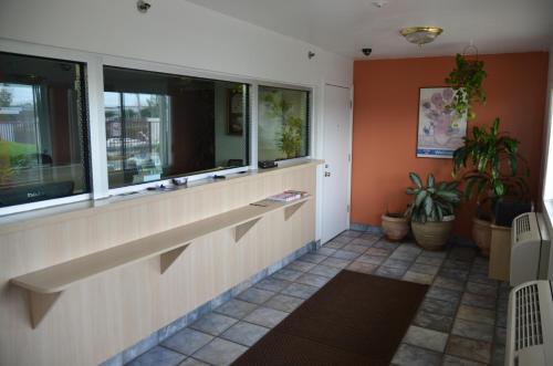 a lobby with windows and plants in a building at Super 7 Inn in Memphis