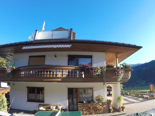a large house with a balcony on top of it at Ferienwohnungen Flörl in Zell am Ziller