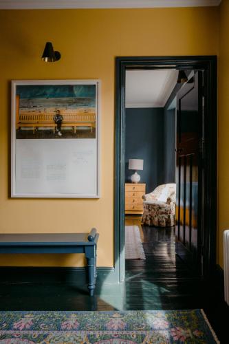 a room with a picture and a bench on a wall at The Rose in Deal