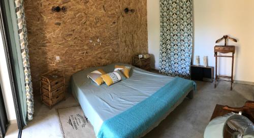 a bedroom with a bed with blue sheets and pillows at Jardin Tropical in Saint-Pierre