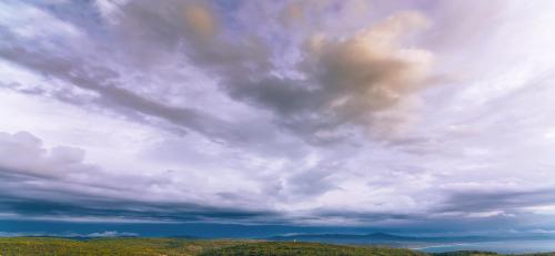 a cloudy sky over a field with trees under it at Limeri Traditional Guest House in Monólithos
