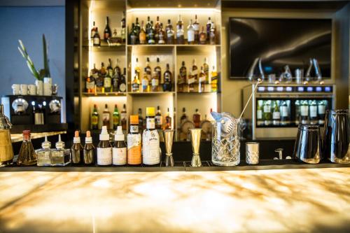 a bar with a lot of bottles of alcohol at Palladio Hotel Buenos Aires - MGallery Collection in Buenos Aires