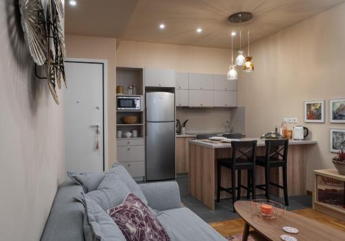a living room with a couch and a kitchen at Absolute Athens v in Athens