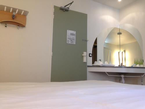 a bathroom with a sink and a mirror at ibis Budget Caen Centre Gare in Caen