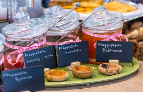 a tray with jars of jam and food on a table at Limeri Traditional Guest House in Monólithos