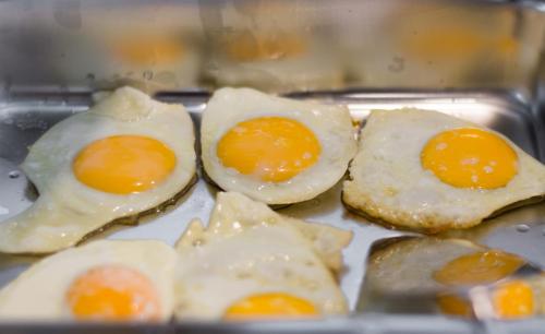 three eggs are sitting on top of a tray at Limeri Traditional Guest House in Monólithos