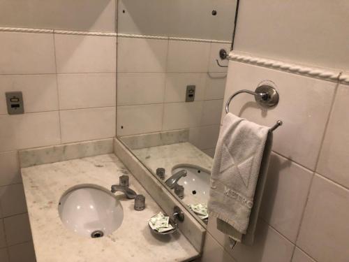 a bathroom with a sink and a toilet at Hotel Metropole in Belo Horizonte