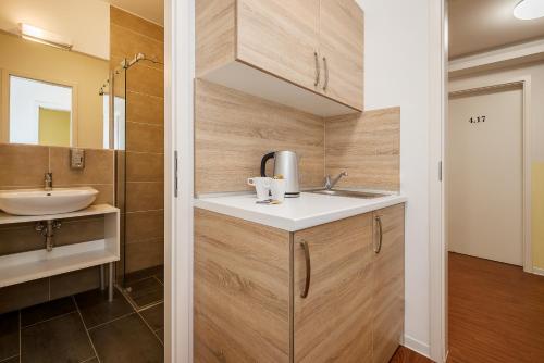 a bathroom with a sink and a mirror at Hotel City Green Berlin in Berlin