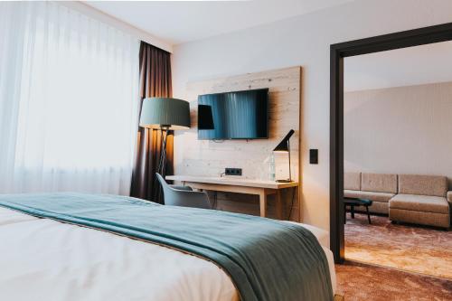 a hotel room with a bed and a desk at FischerS in Kassel