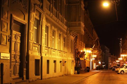 an empty city street at night with a building at Vilnius street apartment in Vilnius
