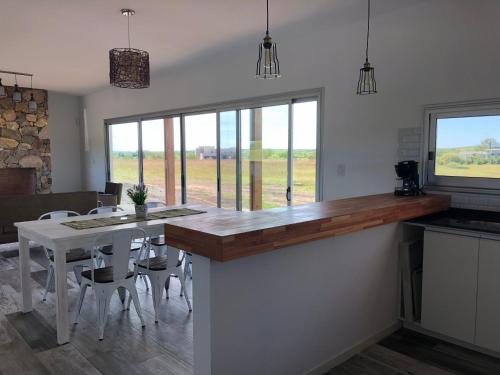 a kitchen with a counter with a table and chairs at Carmelo Golf in Carmelo